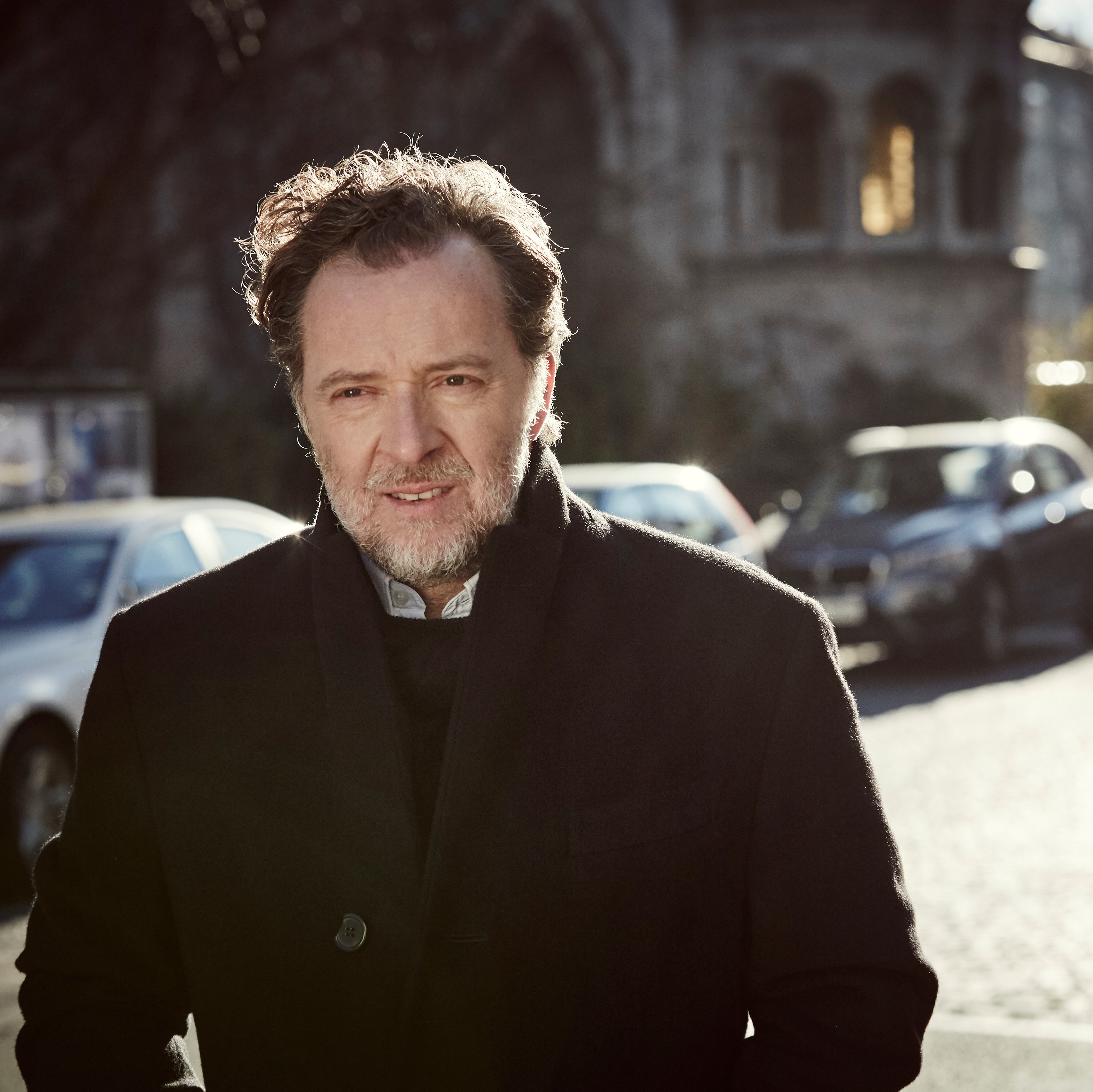 Christian Gerhaher walking down a street in Germany