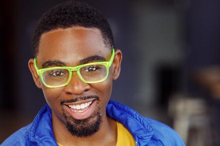 Julian Otis wearing green glasses