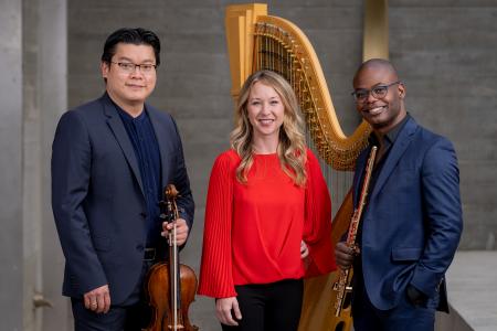 The Myriad Trio posing with their instruments: a flute, a harp, and a viola.