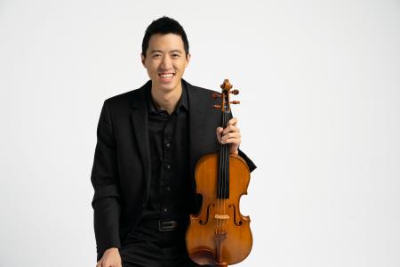 Danny Lai holding a viola.