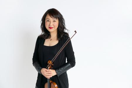 Yuan-Qing Yu holding her violin.