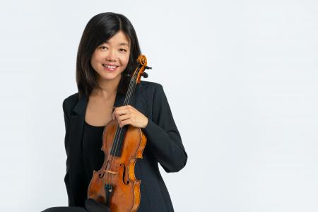 Qing Hou poses with her violin.
