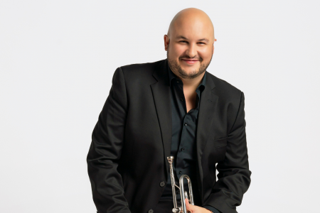 Esteban Batallán poses with his trumpet.