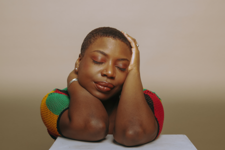 A headshot of a woman with eyes closed.