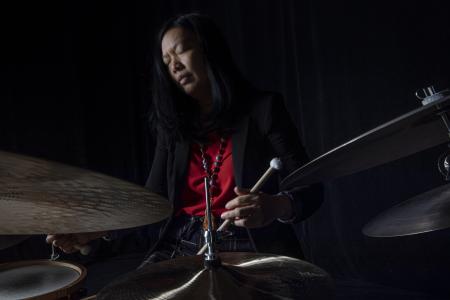 A woman playing the drums
