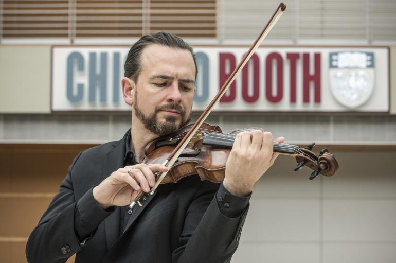John Macfarlane playing violin at the Booth School, UChicago