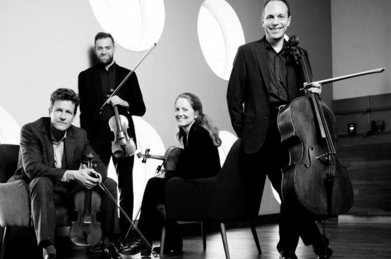 St. Lawrence String Quartet posing with their instruments