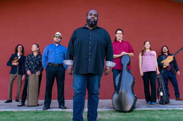 Music ensemble with seven members poses for a group picture