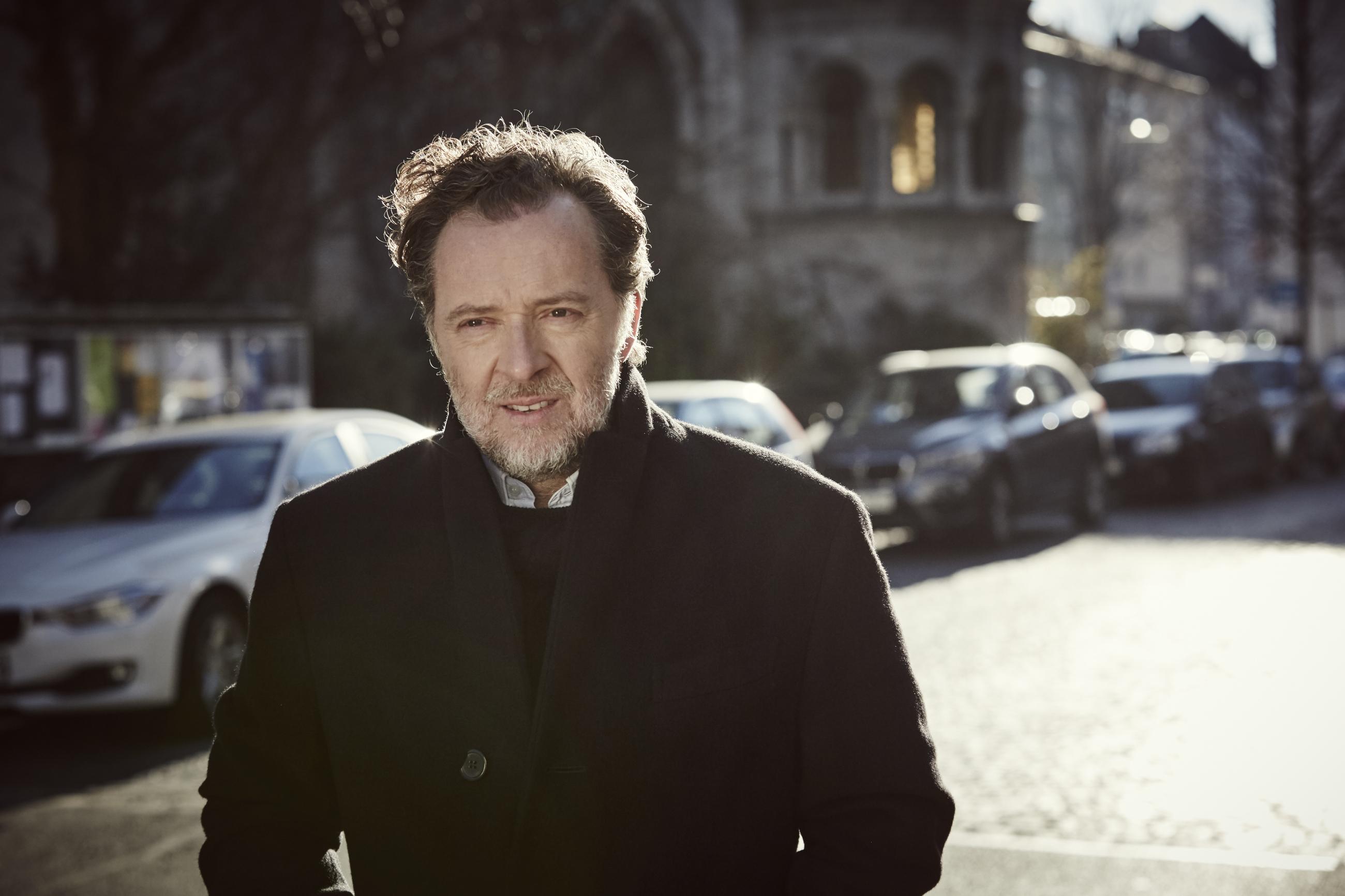 Christian Gerhaher walking down a street in Germany