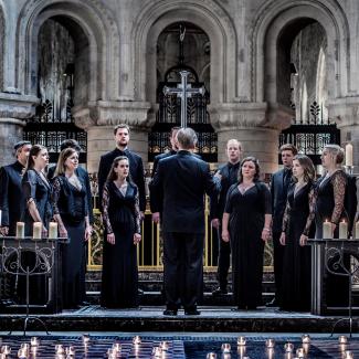 British vocal ensemble Tenebrae in an ornate church singing with Candles on the ground