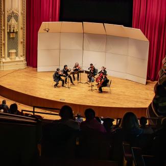 CSO Chamber Music Series Spotify image, featuring a sextet of string musicians performing on Mandel Hall's stage