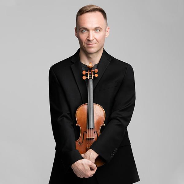Austin Wulliman holding his violin