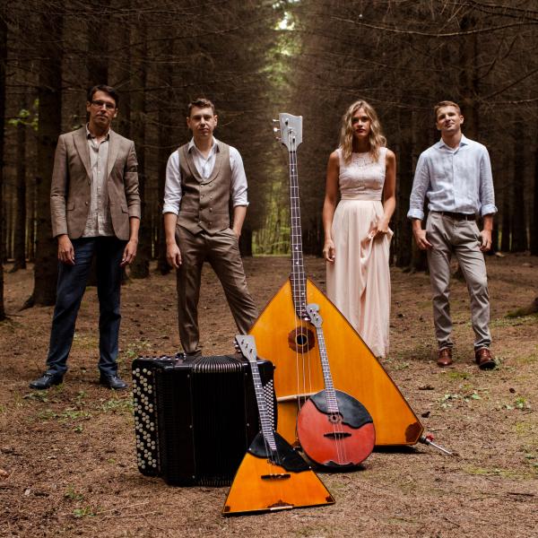 Russian Renaissance standing in the woods behind a pile of their instruments Renaissance with instruments
