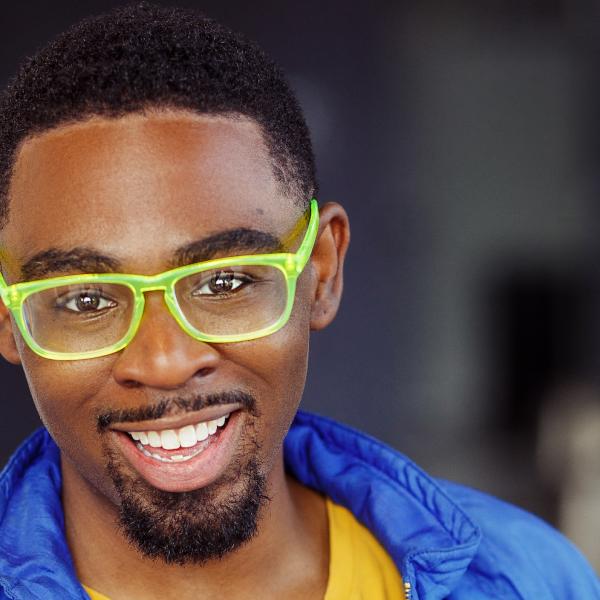 Julian Otis wearing green glasses