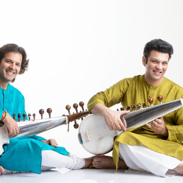Amaan Ali Bangash and Ayaan Ali Bangash seated, posing with their sarods