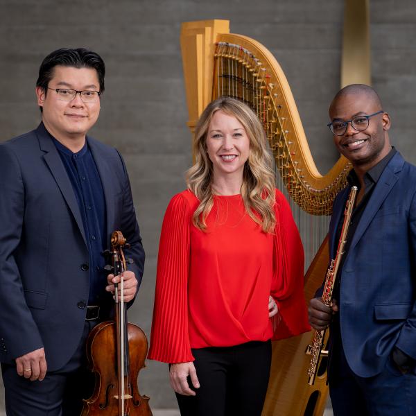The Myriad Trio posing with their instruments: a flute, a harp, and a viola.