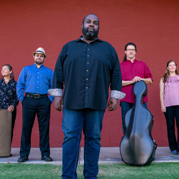 Music ensemble with seven members poses for a group picture