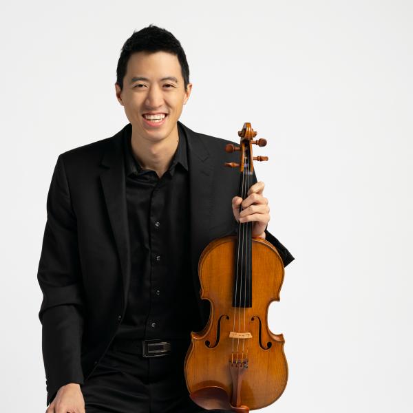 Danny Lai holding a viola.