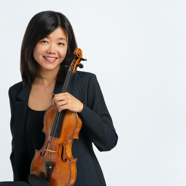 Qing Hou poses with her violin.