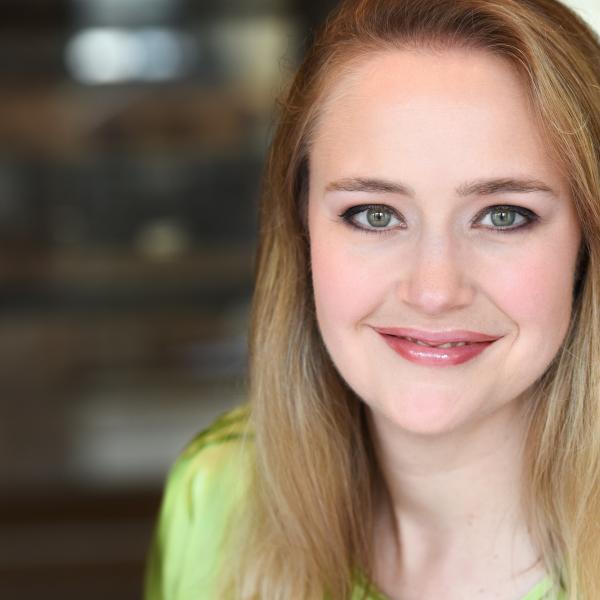 Headshot of a woman smiling in the camera.