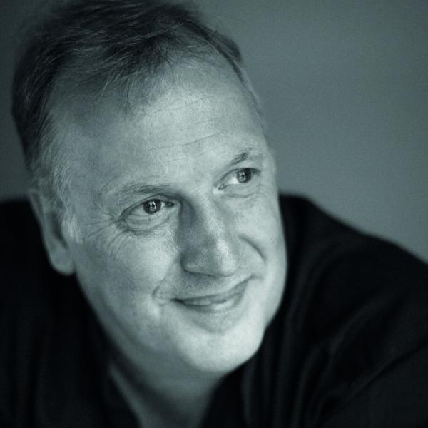 A black and white headshot of a man.