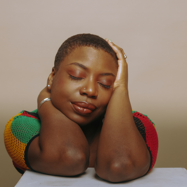 A headshot of a woman with eyes closed.